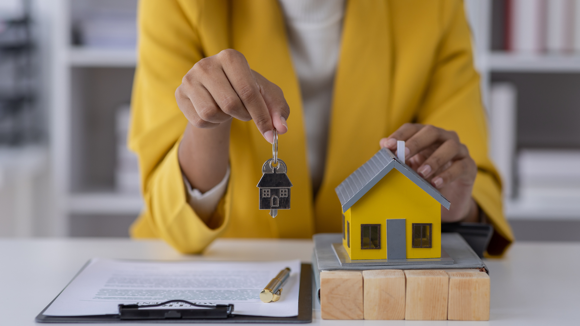 businesswoman hands holding modern house key